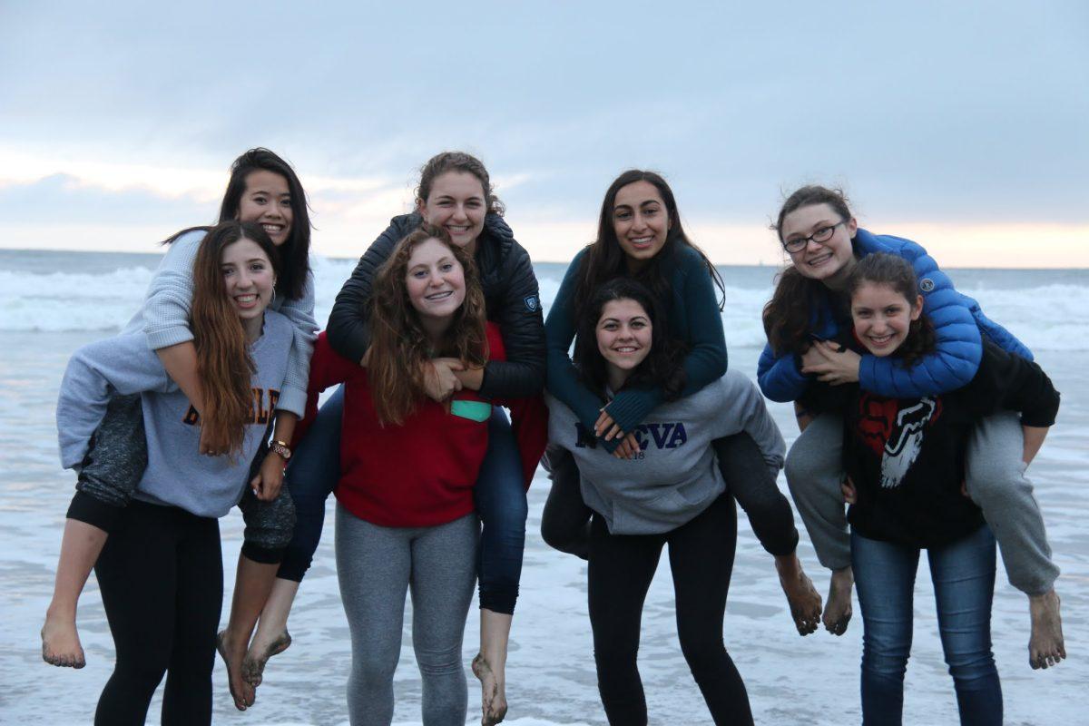 Anika K., Nathalie G., Donya Z., Devon H., Lucy B., Talia S., Thea P., and Julia R. have fun on the beach. Photo by Michael Byun.