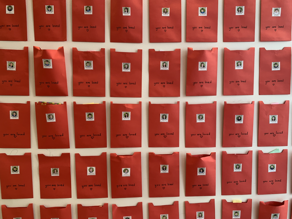 Kindness notes, one of the many Valentine's Day traditions, fill the wall