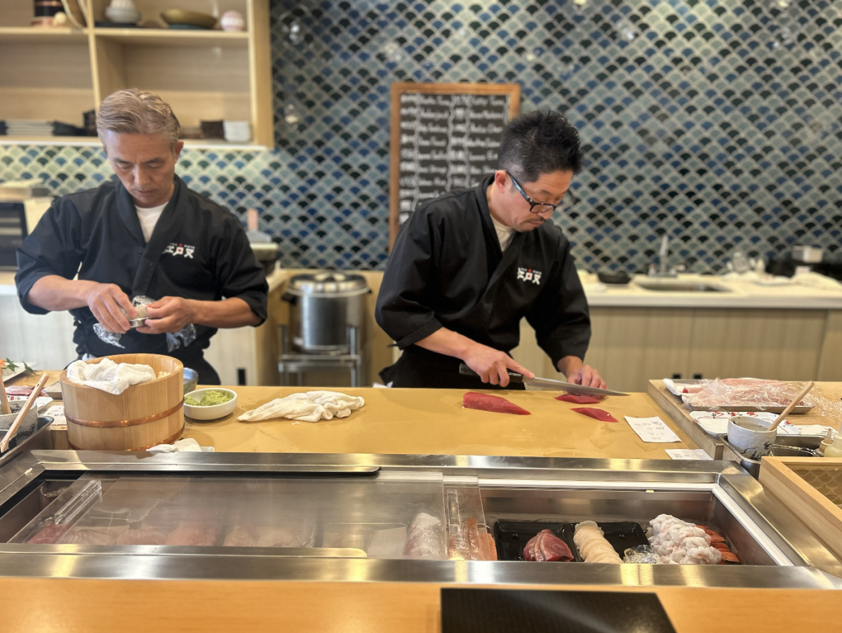 Suchi chefs Yasuo Hara, left, and Koichi Ito, right, prepare fish for a fresh meal.