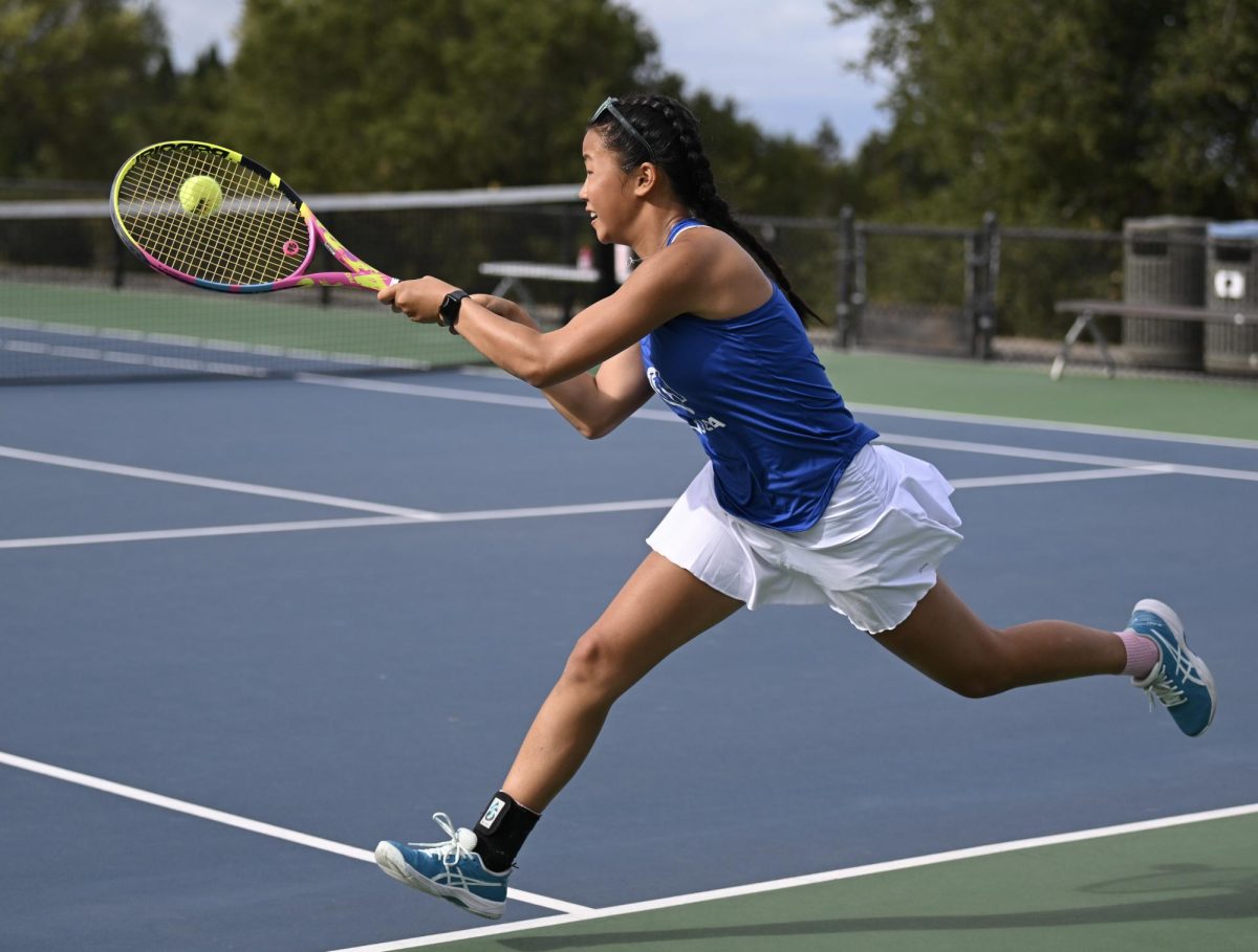 Julia C. ’27 takes a swing at the ball during practice.