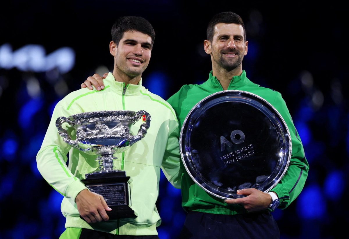 Tennis - Australian Open - Melbourne Park, Melbourne, Australia - February 1, 2026 Spain's Carlos Alcaraz poses with the trophy after winning the Australian Open men's singles alongside runner up Serbia's Novak Djokovic. Alcaraz becomes the youngest man to win all four grand slam titles. REUTERS/Edgar Su
