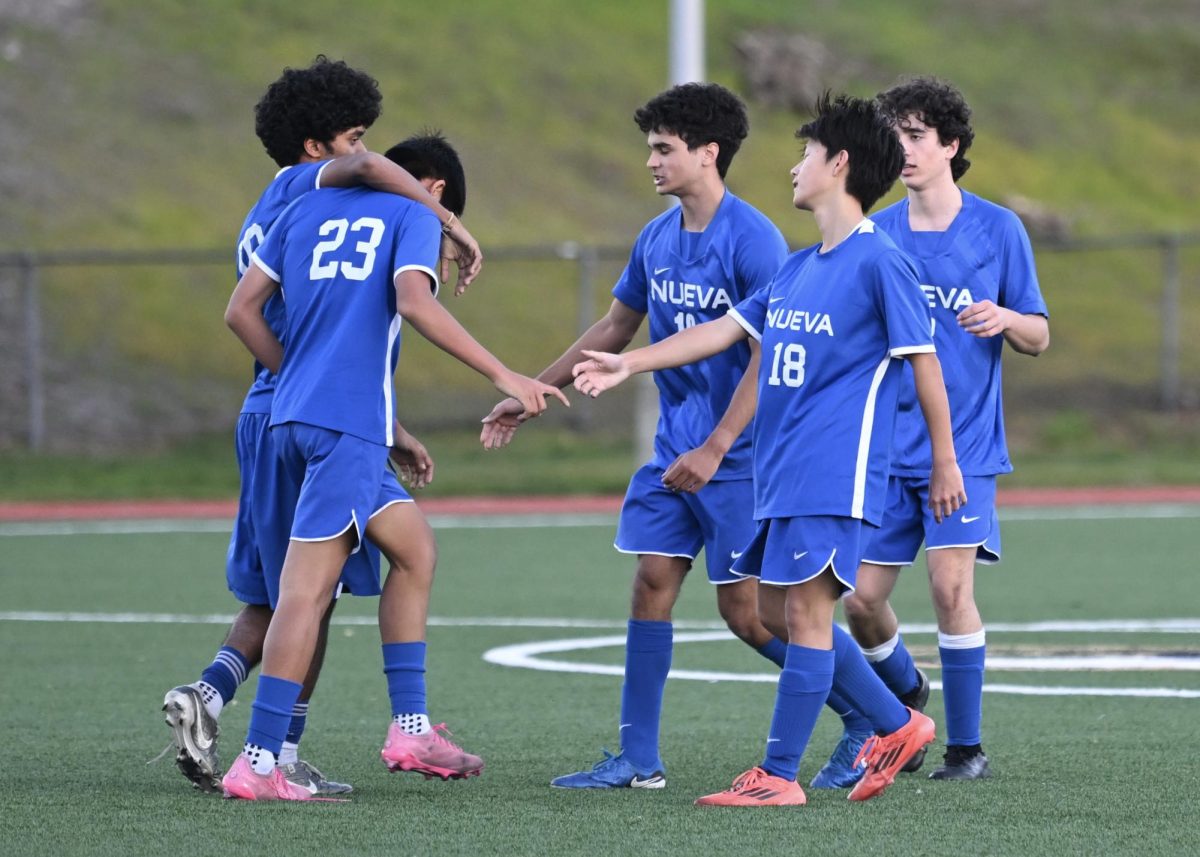 The boys soccer team come together after a game.