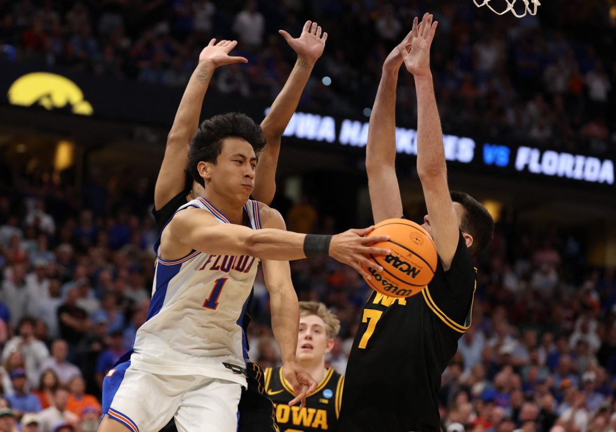 Mar 22, 2026; Tampa, FL, USA; Florida Gators guard Xaivian Lee (1) passes the ball around Iowa Hawkeyes forward Alvaro Folgueiras (7) in the final seconds as Florida Gators was unable to get a shot off in the second half during a second round game of the men's 2026 NCAA Tournament at Benchmark International Arena. Mandatory Credit: Matt Pendleton-Imagn Images
