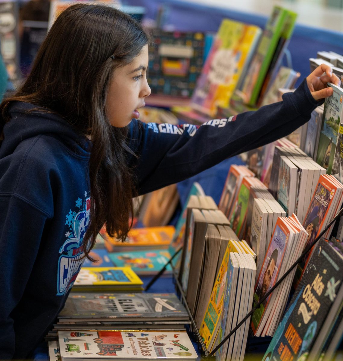 Browsing Books // A student explores the curated book displays.