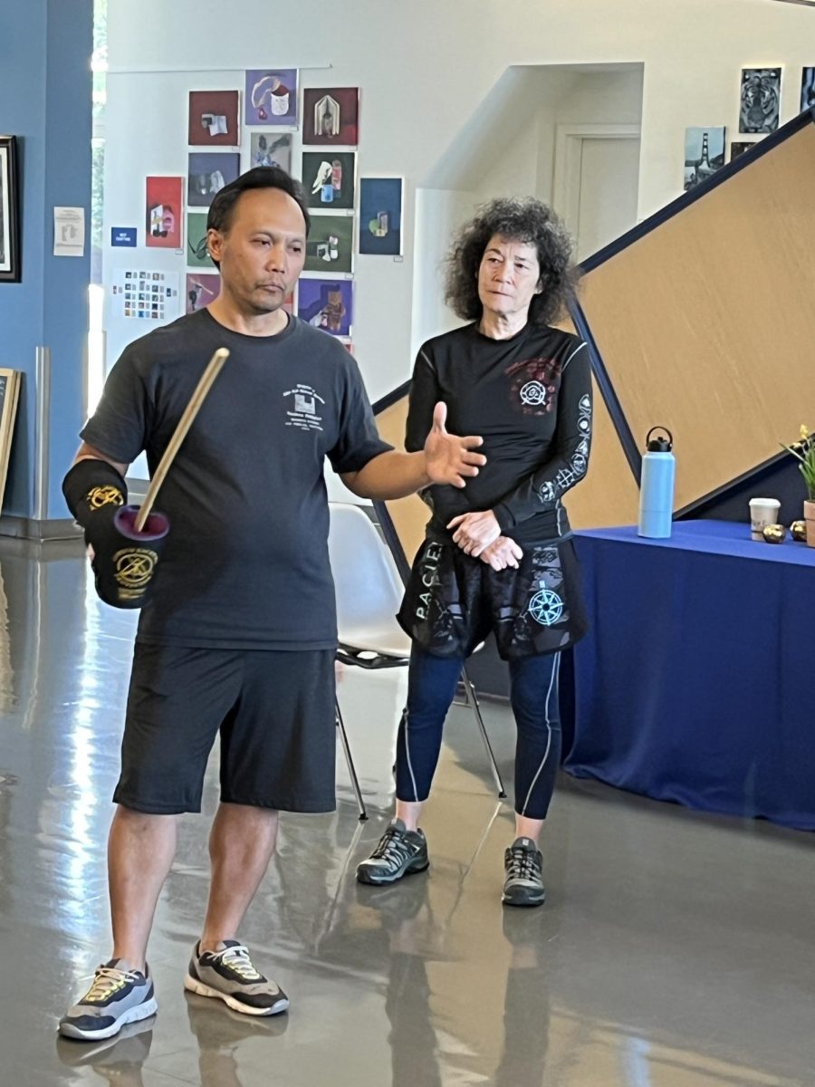 During the Filipino Affinity Group
martial arts workshop, participants hold out swords. 