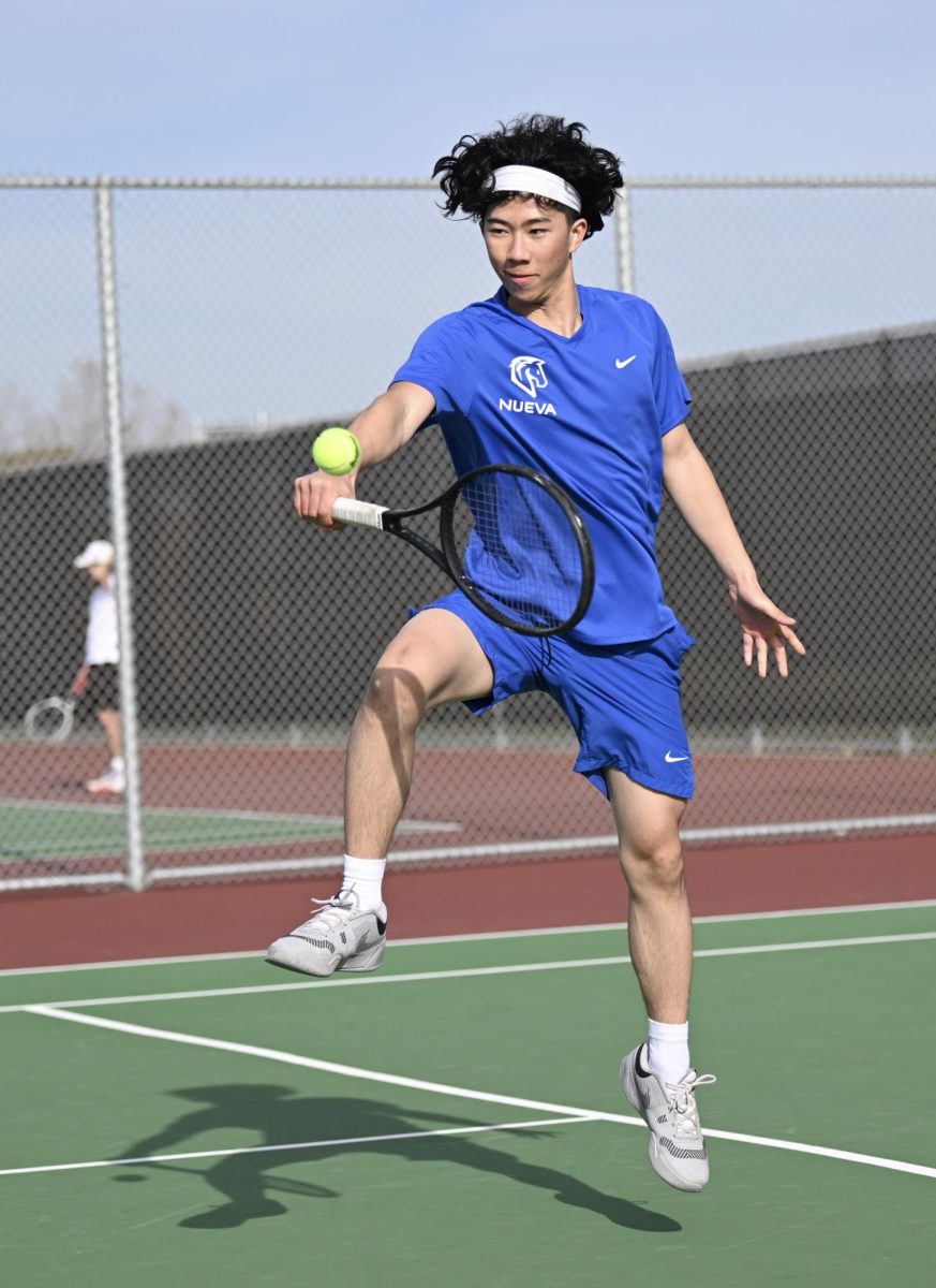 Serving Season: Jackson Lee '25 catching a ball with his racket. // Photo by Bradley Collier