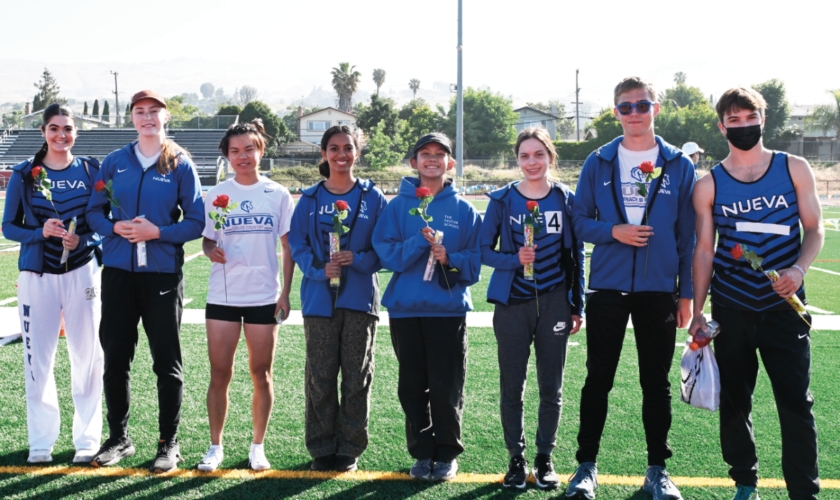 Nueva's track seniors hold their roses on their senior night. 
